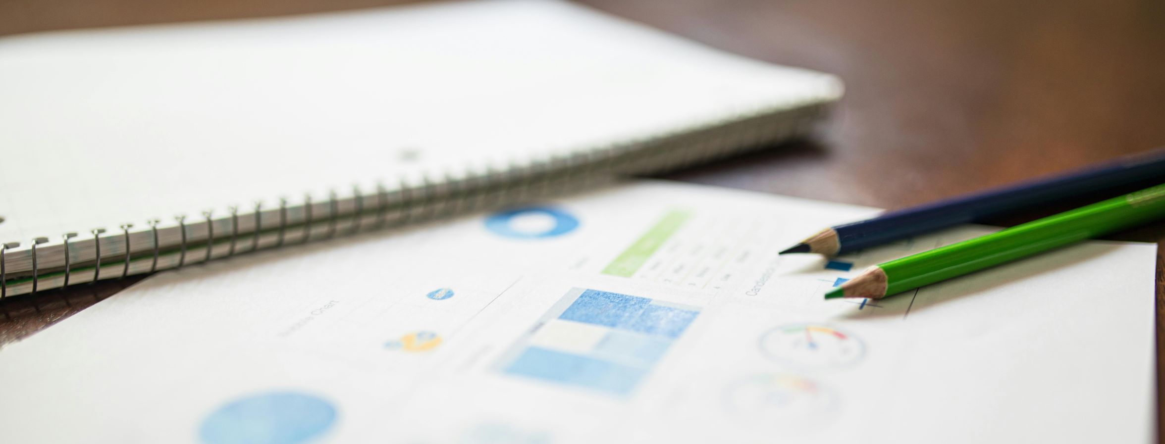 Papers on table showing charts. 